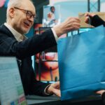 Man buying items from store after hearing instore radio